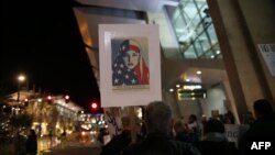 FILE - Protesters chant during a rally against the travel ban at San Diego International Airport, March 6, 2017.