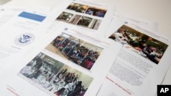FILE - A portion of a report from government auditors reveals images of people penned into overcrowded Border Patrol facilities, photographed July 2, 2019, in Washington.