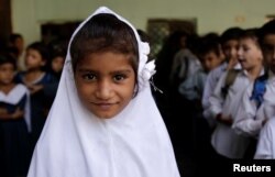 A girl attends morning assembly at the Mashal Model school in Islamabad, Pakistan, Sept. 29, 2017.