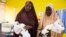 Hajia Muhammed’s relatives carry her healthy twin boys. She delivered with a C-section because one of the twins was in a breeched position in Kaduna, Nigeria. (Photo: Chika Oduah for VOA) 
