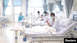 A screen grab shows boys rescued from the Thai cave wearing mask and resting in a hospital in Chiang Rai, Thailand from a July 11, 2018 handout video. (Government Public Relations Department (PRD) and Government Spokesman Bureau/Handout via Reuters TV) 