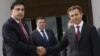 Georgian President Mikhail Saakashvili, left, and Bidzina Ivanishvili, right, the likely new prime minister, shake hands before their meeting at the Presidential Palace in Tbilisi, October 9, 2012.