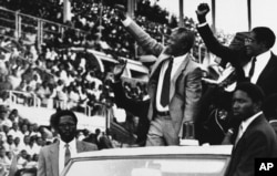 Nelson Mandela, center, and Zimbabwe President Robert Mugabe, far right, appear together in Zimbabwe in March 5, 1990, Harare, Zimbabwe. (AP Photo)