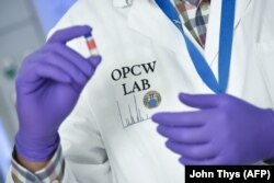 NETHERLANDS -- A laboratory technician controls a test vial at the OPCW (The Organisation for the Prohibition of Chemical Weapons) headquarters in the Hague, April 20, 2017
