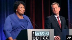Democratic gubernatorial candidate for Georgia Stacey Abrams, left, speaks as her Republican opponent Secretary of State Brian Kemp looks on during a debate in Atlanta, Oct. 23, 2018.