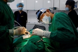 FILE PHOTO Park Cheol-woo a director of WooAhIn Plastic Surgery Clinic conducts a nose plastic surgery of Ryu Han-na, amid the coronavirus disease (COVID-19) pandemic in Seoul, South Korea, December 17, 2020. Picture taken on December 17, 2020. REUTERS/Kim Hong-Ji