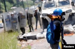 A demonstrator throws a molotov cocktail at security forces during clashes at a rally against Venezuelan President Nicolas Maduro's government in Caracas, Venezuela, July 18, 2017.