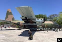 Taiwan coast guard secure a C-130 military transport plane on the tarmac of Taiping island, also known as Itu Aba, in the Spratly archipelago, roughly 1600 kms. (1000 miles) south of Taiwan, March 23, 2016.