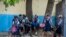Student wait their turn to enter Lycee Marie Jeanne school on first day of school since the COVID-19 pandemic in Port-au-Prince, Haiti, Monday, Aug. 17, 2020. (AP Photo/Dieu Nalio Chery)