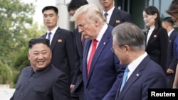 FILE - U.S. President Donald Trump, North Korean leader Kim Jong Un and South Korean President Moon Jae-in leave after a meeting at the demilitarized zone separating the two Koreas, in Panmunjom, South Korea, June 30, 2019.
