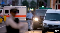 A police forensic officer works in Russell Square in London early on August 4, 2016, after a knife attack in which a woman in her 60s was killed.