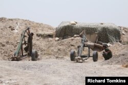 FILE - Fighters of the Syria Democratic Forces prepare to fire a mortar shell towards positions held by Islamic State fighters in northern province of Raqqa, Syria, May 27, 2016.