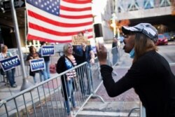 Jessica Ashley, a supporter of President-elect Joe Biden, shouts towards supporters of President Donald Trump, the day after a presidential election victory was called for Biden, in Philadelphia, Pennsylvania, Nov. 8, 2020.