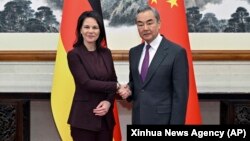 German Foreign Minister Annalena Baerbock, left, meets with Chinese counterpart Minister Wang Yi in Beijing, Dec. 2, 2024. 