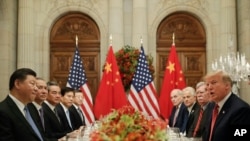 FILE - President Donald Trump, right, with China's President Xi Jinping, left, during their bilateral meeting at the G20 Summit, Saturday, Dec. 1, 2018 in Buenos Aires, Argentina. 