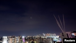 Rockets are fired towards Israel from the northern Gaza Strip, as seen from Ashkelon, southern Israel