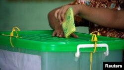 FILE - A voter cast her ballot for the by-election in Yangon, Myanmar, Nov. 3, 2018. 