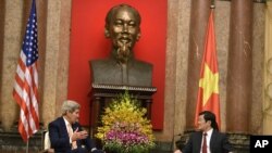 FILE - U.S. Secretary of State John Kerry, left, and Vietnamese President Truong Tan Sang talks during a meeting at the Presidential Palace in Hanoi, Vietnam, Friday, Aug. 7, 2015.