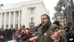 Protesters take cover behind homemade shields as they confront the police during a crackdown on demonstrations against the military coup in Yangon, Myanmar.