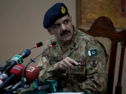 FILE - Pakistan's army spokesman Major-General Asim Bajwa briefs the media in Peshawar, Pakistan, Dec. 16, 2014.