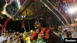 A Hindu devotee walks in a trance to Batu Caves during Thaipusam in Kuala Lumpur, Malaysia, Jan. 24, 2016.