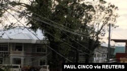 Fallen power lines dangle over buildings after Typhoon Phanfone swept through Tanauan, Leyte, in the Philippines. Dec. 25, 2019, in this photo obtained from social media.