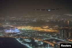 Solar Impulse 2, the solar powered plane, piloted by Swiss pioneer Bertrand Piccard, is seen before landing in Abu Dhabi to finish the first around the world flight without the use of fuel, United Arab Emirates July 26, 2016.