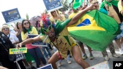 A demonstrator shouts slogans against suspended Brazilian President Dilma Rousseff during a protest demanding her impeachment, on Copacabana beach, in Rio de Janeiro, Brazil, Sunday, July 31, 2016.
