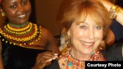 Jacqueline Kamsu tries one of her handmade necklaces on an American customer. (Kamsu)