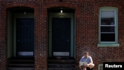 Jack Coopersmith sits outside his apartment and takes part in remote meeting while working from home amid the coronavirus disease (COVID-19) outbreak in Cambridge, Massachusetts, May 22, 2020.