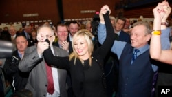 Sinn Fein's party leader for Northern Ireland Michelle O'Neill celebrates with party members Francie Molloy (left) and Ian Milne (right) after topping the poll in Mid Ulster, Ballymena count centre, Northern Ireland, March 3, 2017.