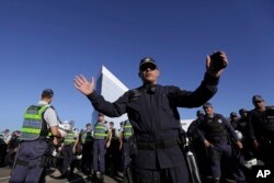 Military police stand guard outside the headquarters of the Superior Electoral Court in Brasilia, Brazil, June 7, 2017.