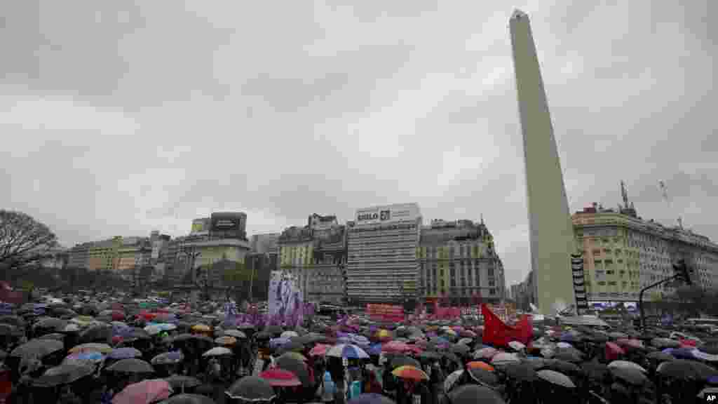 People dressed in black demonstrate against gender violence, under the rain in Buenos Aires, Argentina, Oct. 19, 2016, after the recent rape and killing of a 16-year-old girl.
