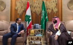FILE - In this Oct. 30, 2017 photo, Saudi Crown Prince Mohammed bin Salman, right, meets with Lebanese Prime Minister Saad Hariri in Riyadh, Saudi Arabia.