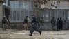 Afghan police and special forces surround the area after suicide bombers armed with assault rifles and hand grenades attacked a guesthouse used by foreigners in Kabul, March 28, 2014.