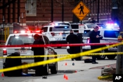 FILE - In this Nov. 28, 2016 file photo, crime scene investigators collect evidence from the pavement as police respond to an attack on campus at Ohio State University, in Columbus, Ohio.