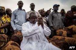FILE - Adama Barrow, the flag-bearer of the coalition of the seven opposition political parties in Gambia, greets supporters during a gathering in the Buffer Zone district of Talinding, Nov. 29, 2016.