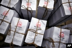 Copies of the newly adopted constitution lie bundled together for distribution to lawmakers at the constituent assembly hall in Kathmandu, Nepal, Sep 20, 2015.