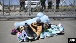 Shoes are left by people at the Tornillo Port of Entry near El Paso, Texas during a protest rally by several American mayors against the US administration's family separation policy.