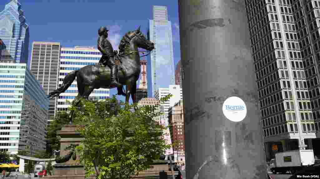 A Bernie Sanders supporter leaves a sticker behind outside the Reading Terminal Market in downtown Philadelphia, July 26, 2016. (Mia Bush/VOA)