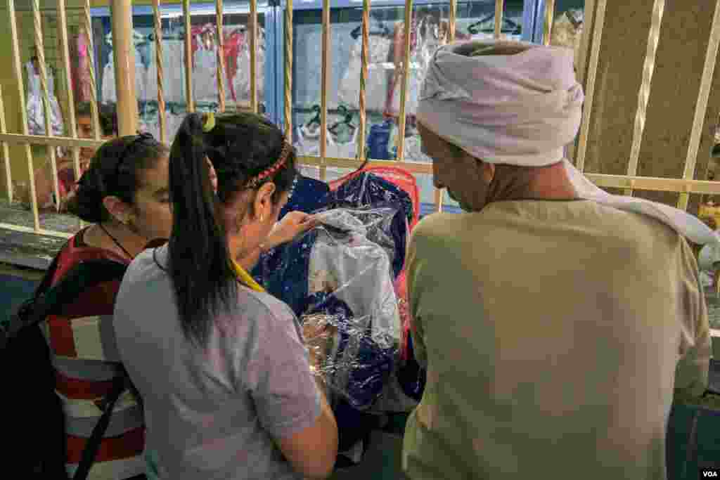 Coptic parents are buying new clothes for just baptized small children; boys dress as bishops while girls dress like brides. Sunday, August 18, 2019.