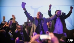 Attendees shout slogans prior to a plenary session at the Congress of Syrian National Dialogue in Sochi, Jan. 30, 2018.