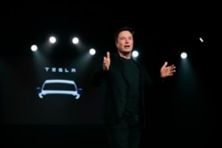 FILE - Tesla CEO Elon Musk speaks before unveiling the Model Y at Tesla's design studio in Hawthorne, California, March 14, 2019.