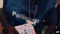 Polling agents count ballots for the Liberian presidential election at a polling station in Monrovia, October 11, 2011.