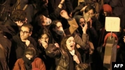 An Iranian man checks a local newspaper headline that reads "National Mourning" referring to the downed Ukrainian jetliner outside the capital Tehran last week, in front of a news stand in Tehran, Jan. 12, 2020.