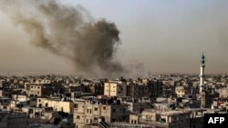 Smoke billows over buildings following Israeli bombardment in Rafah in the southern Gaza Strip on March 27, 2024, amid the ongoing conflict between Israel and the Palestinian militant group Hamas.