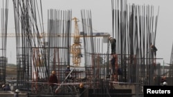 Laborers work at a construction site in Phnom Penh. Cambodia's economy is projected to expand by 7.3 percent in 2015, up from 7 percent in 2014, and will climb to 7.5 percent next year, Asian Development Bank (ADB) said in its Asian Development Outlook 20