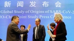 Marion Koopmans, right, and Peter Ben Embarek, center, of the World Health Organization team say farewell to their Chinese counterpart Liang Wannian, left, after a WHO-China Joint Study Press Conference held at the end of the WHO mission in Wuhan, China,