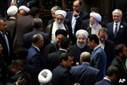 Iran's President Hasan Rouhani, center, leaves the parliament at the end of his swearing-in ceremony for the second term in office, in Tehran, Iran, Aug. 5, 2017.