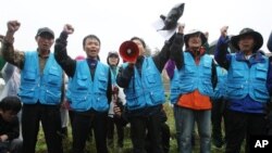 22일 임진각 주변에서 경차릐 통제로 대북 전단 살포에 실패하자 구호를 외치는 한국 탈북단체 관계자들. 이들은 강화도로 장소를 옮겨 대북 전단 12만장을 북한으로 날려보냈다.